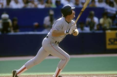 CIRCA 1991: Third Baseman Wade Boggs #26 of the Boston Red Sox swings and watches the flight of his ball during a Major League Baseball game circa 1991. Boggs played for the Red Sox from 1982-92. (Photo by Focus on Sport/Getty Images)