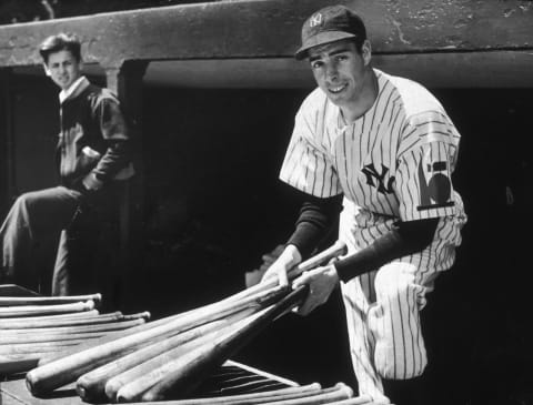 CIRCA 1939: (FILE PHOTO) New York Yankees outfielder, Joe DiMaggio holds a few baseball bats while in uniform circa 1939 in an undisclosed location. (Photo by New York Times Co./Getty Images)