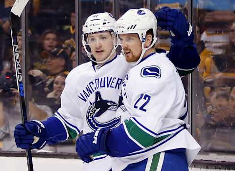 Jan 21, 2016; Boston, MA, USA; Vancouver Canucks left wing Daniel Sedin (22) is congratulated after his goal by center Jared McCann (91) during the third period of the Vancouver Canucks 4-2 win over the Boston Bruins at TD Garden. Mandatory Credit: Winslow Townson-USA TODAY Sports