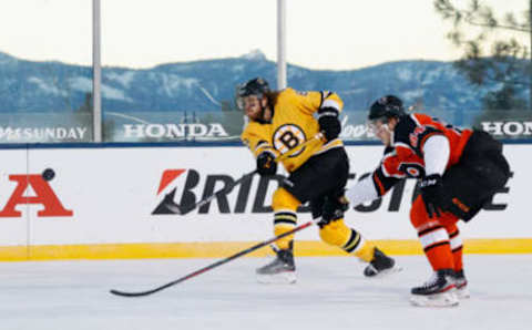 STATELINE, NEVADA – FEBRUARY 21: David Pastrnak #88 of the Boston Bruins shoots the puck past Maksim Sushko #64 of the Philadelphia Flyers during the ‘NHL Outdoors At Lake Tahoe’ at the Edgewood Tahoe Resort on February 21, 2021 in Stateline, Nevada. The Bruins defeated the Flyers 7-3. (Photo by Christian Petersen/Getty Images)