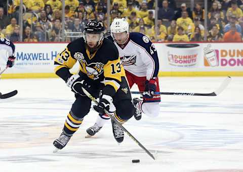 Apr 12, 2017; Pittsburgh, PA, USA; Pittsburgh Penguins center Nick Bonino (13) moves the puck ahead of Columbus Blue Jackets left wing Scott Hartnell (43) during the second period in game one of the first round of the 2017 Stanley Cup Playoffs at PPG PAINTS Arena. The Penguins won 3-1. Mandatory Credit: Charles LeClaire-USA TODAY Sports