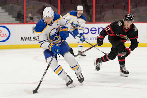 Jan 25, 2022; Ottawa, Ontario, CAN; Buffalo Sabres defenseman Mark Pysyk (13) skates with the puck in front of Ottawa Senators left wing Alex Formenton (10) in the second period at the Canadian Tire Centre. Mandatory Credit: Marc DesRosiers-USA TODAY Sports