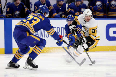 Mar 23, 2022; Buffalo, New York, USA; Pittsburgh Penguins center Sidney Crosby (87) skates with the puck as Buffalo Sabres defenseman Jacob Bryson (78) and defenseman Mattias Samuelsson (23) defend during the first period at KeyBank Center. Mandatory Credit: Timothy T. Ludwig-USA TODAY Sports