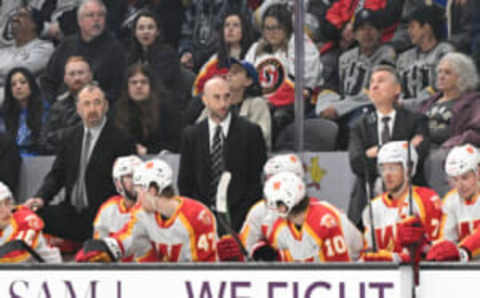 HENDERSON, NEVADA – FEBRUARY 26: Mitch Love, head coach of the Calgary Wranglers on the bench in the game against the Henderson Silver Knights at The Dollar Loan Center on February 26, 2023 in Henderson, Nevada. The Silver Knights defeated the Wranglers 2-1. (Photo by Candice Ward/Getty Images)