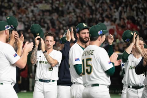 Australia’s players applaud the Japanese fans following their loss Sunday. (Photo by Richard A. Brooks / AFP)