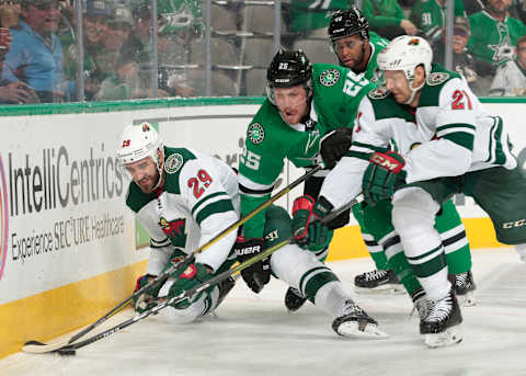 DALLAS, TX – OCTOBER 19: Greg Pateryn #29 and Eric Fehr #21 of the Minnesota Wild try to keep the puck away against Brett Ritchie #25 of the Dallas Stars at the American Airlines Center on October 19, 2018 in Dallas, Texas. (Photo by Glenn James/NHLI via Getty Images)