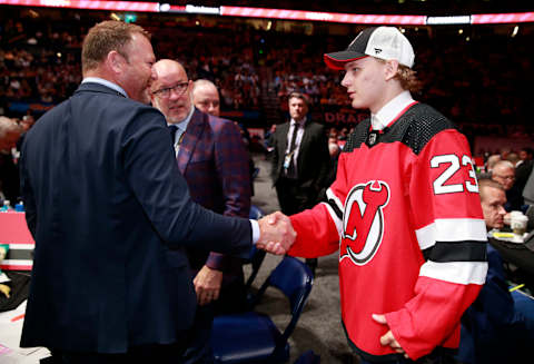 Lenni Hameenaho shakes hands with Martin Brodeur. (Photo by Jeff Vinnick/NHLI via Getty Images)