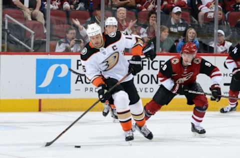 GLENDALE, AZ – APRIL 07: Ryan Getzlaf #15 of the Anaheim Ducks advances the puck up ice ahead of Clayton Keller #9 of the Arizona Coyotes during the first period at Gila River Arena on April 7, 2018, in Glendale, Arizona. (Photo by Norm Hall/NHLI via Getty Images)