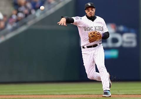 DENVER, CO – OCTOBER 07: Nolan Arrenado #28 of the Colorado Rockies throws out Travis Shaw #21 of the Milwaukee Brewers in the fourth inning of Game Three of the National League Division Series at Coors Field on October 7, 2018 in Denver, Colorado. (Photo by Matthew Stockman/Getty Images)