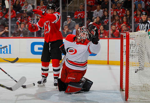 NEWARK, NJ – MARCH 27: Scott Darling #33 of the Carolina Hurricanes surrenders a goal as Miles Wood #44 of the New Jersey Devils starts to celebrate on March 27, 2018 at Prudential Center in Newark, New Jersey. The Devils defeated the Hurricanes 4-3. (Photo by Jim McIsaac/NHLI via Getty Images)