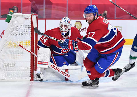 MONTREAL, QC – FEBRUARY 02: Brett Kulak #77 of the Montreal Canadiens skates as goaltender Jake Allen #34 tends goal against the Vancouver Canucks during the first period at the Bell Centre on February 2, 2021 in Montreal, Canada. The Montreal Canadiens defeated the Vancouver Canucks 5-3. (Photo by Minas Panagiotakis/Getty Images)