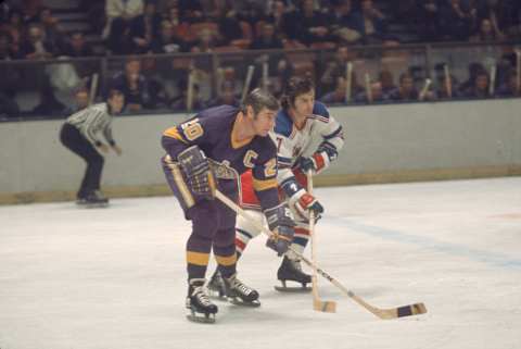 Canadian professional ice hockey player Bob Pulford (right) of the Los Angeles Kings tussles with opponent Rod Gilbert on the ice during an away game against the New York Rangers, Madison Square Garden, New York, early 1970s. Pulford played for the Kings from 1970 to 1972 and Gilbert for the Rangers from 1960 to 1978. (Photo by Melchior DiGiacomo/Getty Images)