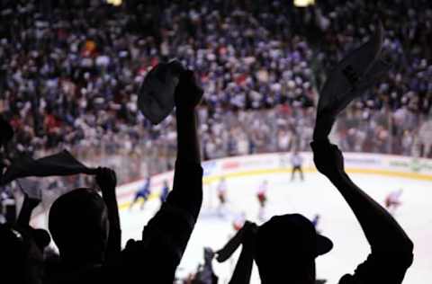 Apr 17, 2015; Vancouver, British Columbia, CAN; Vancouver Canucks fans celebrate the win against the Calgary Flames during the third period in game two of the first round of the 2015 Stanley Cup Playoffs at Rogers Arena. The Vancouver Canucks won 4-1. Mandatory Credit: Anne-Marie Sorvin-USA TODAY Sports