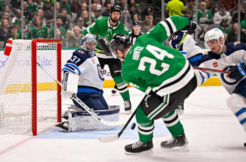 Oct 17, 2022; Dallas, Texas, USA; Winnipeg Jets goaltender Connor Hellebuyck (37) faces a shot by Dallas Stars center Roope Hintz (24) during the second period at the American Airlines Center. Mandatory Credit: Jerome Miron-USA TODAY Sports