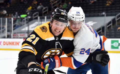 May 10, 2021; Boston, Massachusetts, USA; Boston Bruins left wing Nick Ritchie (21) and New York Islanders defenseman Nick Leddy (2) battle for position during the second period at TD Garden. Mandatory Credit: Bob DeChiara-USA TODAY Sports