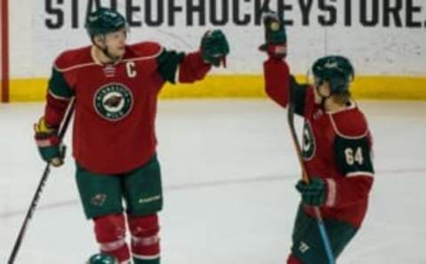 Dec 5, 2014; Saint Paul, MN, USA; Minnesota Wild forward Mikko Koivu (9) celebrates with forward Mikael Granlund (64) after scoring a goal during the second period against the Anaheim Ducks at Xcel Energy Center. Mandatory Credit: Brace Hemmelgarn-USA TODAY Sports