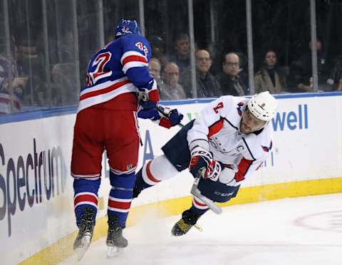 Alex Ovechkin of the Washington Capitals bounces off Brendan Smith of the New York Rangers. (Photo by Bruce Bennett/Getty Images)