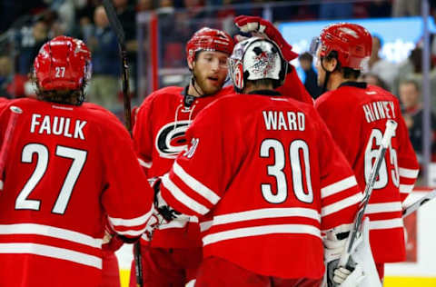 Nov 15, 2016; Raleigh, NC, USA; Carolina Hurricanes goalie Cam Ward (30) is congratulated by teammate defensemen Jaccob Slavin (74) after there victory against the San Jose Sharks at PNC Arena. The Carolina Hurricanes defeated the San Jose Sharks 1-0. Mandatory Credit: James Guillory-USA TODAY Sports