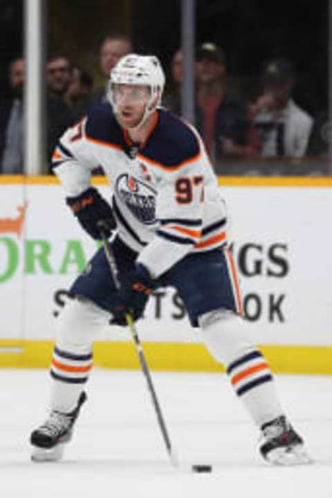 NASHVILLE, TENNESSEE – APRIL 14: Connor McDavid #97 of the Edmonton Oilers looks to pass the puck against the Nashville Predators at Bridgestone Arena on April 14, 2022 in Nashville, Tennessee. (Photo by Donald Page/Getty Images)