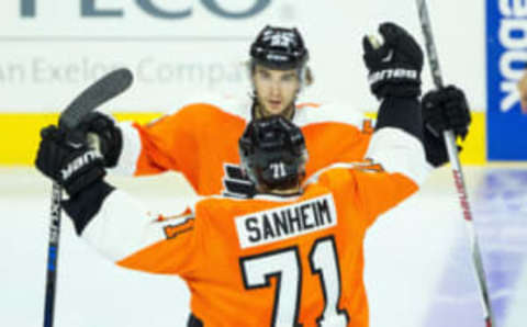 Sep 22, 2015; Philadelphia, PA, USA; Philadelphia Flyers defenseman Shayne Gostisbehere (53) celebrates his first goal of the game with defenseman Travis Sanheim (71) during the third period against the New York Rangers at Wells Fargo Center. The Flyers won 5-3. Mandatory Credit: Bill Streicher-USA TODAY Sports