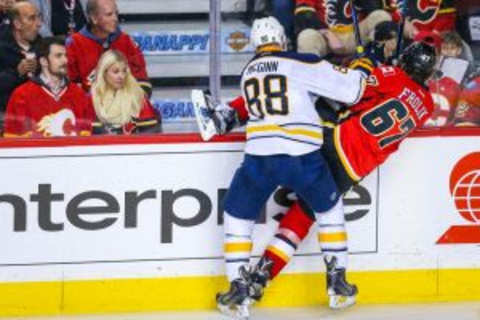 Dec 10, 2015; Calgary, Alberta, CAN; Buffalo Sabres left wing Jamie McGinn (88) checks into the boards Calgary Flames right wing Michael Frolik (67) during the third period at Scotiabank Saddledome. Calgary Flames won 4-3. Mandatory Credit: Sergei Belski-USA TODAY Sports