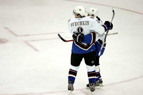 RALEIGH, NC – OCTOBER 12: Alexander Ovechkin #8 of the Washington Capitals celebrates with teammate Andrew Cassels #25 after scoring a goal assisted by Cassels in the first period against the Carolina Hurricanes on October 12, 2005 at the RBC Center in Raleigh, North Carolina. (Photo By Streeter Lecka)