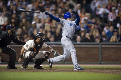 Jul 2, 2008; San Francisco, CA, USA; Chicago Cubs outfielder Jim Edmonds (right) hits a two-run home run in front of San Francisco Giants catcher Eliezer Alfonso (center) during the sixth inning at AT&T Park in San Francisco, CA. Mandatory Credit: Kyle Terada-USA TODAY Sports