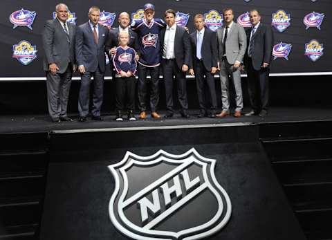 Jun 26, 2015; Sunrise, FL, USA; Gabriel Carlsson poses for a photo with team officials after being selected as the number twenty-nine overall pick to the Columbus Blue Jackets in the first round of the 2015 NHL Draft at BB&T Center. Mandatory Credit: Steve Mitchell-USA TODAY Sports