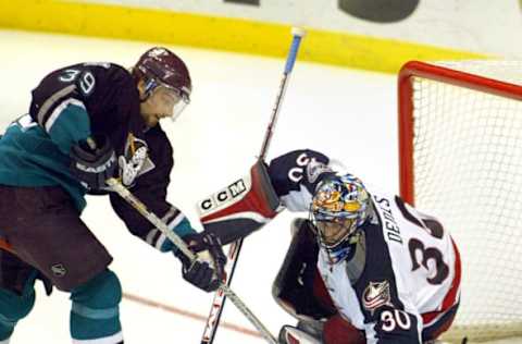 (Anaheim, CA) (1/11/03) (left) Petr Sykora (39) of the Ducks tries to control the puck as Blue Jackets’ goalie Mark Denis (30) (right) makes the stop in the third period. (Photo by Robert Lachman/Los Angeles Times via Getty Images)