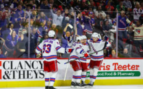 RALEIGH, NC – MARCH 23: Mika Zibanejad #93, Vladimir Tarasenko #91, Adam Fox #23, and Niko Mikkola #77 of the New York Rangers celebrate a goal during the third period of the game against the Carolina Hurricanes at PNC Arena on March 23, 2023 in Raleigh, North Carolina. (Photo by Jaylynn Nash/Getty Images)