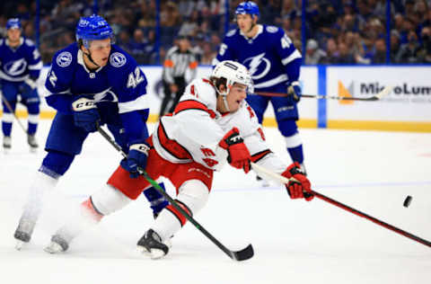 TAMPA, FLORIDA – OCTOBER 01: Otto Somppi #42 of the Tampa Bay Lightning and Jamieson Rees #81 of the Carolina Hurricanes fight for the puck during a preseason game at Amalie Arena on October 01, 2021, in Tampa, Florida. (Photo by Mike Ehrmann/Getty Images)