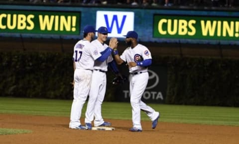 Sep 21, 2016; Chicago, IL, USA; Chicago Cubs third baseman Kris Bryant (17) first baseman Anthony Rizzo (center) and right fielder Jason Heyward (22) celebrate their win against the Cincinnati Reds at Wrigley Field. The Cubs won 9-2. Mandatory Credit: David Banks-USA TODAY Sports