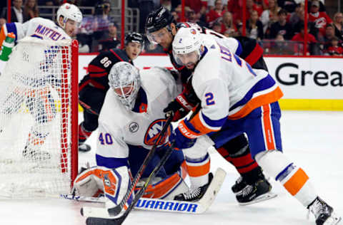 RALEIGH, NC – May 1: Nino Niederreiter #21 of the Carolina Hurricanes battles between goaltender Robin Lehner #40 and Nick Leddy #2 of the New York Islanders in Game Three of the Eastern Conference Second Round during the 2019 NHL Stanley Cup Playoffs at PNC Arena on May 1, 2019, in Raleigh, North Carolina. (Photo by Karl DeBlaker/NHLI via Getty Images)