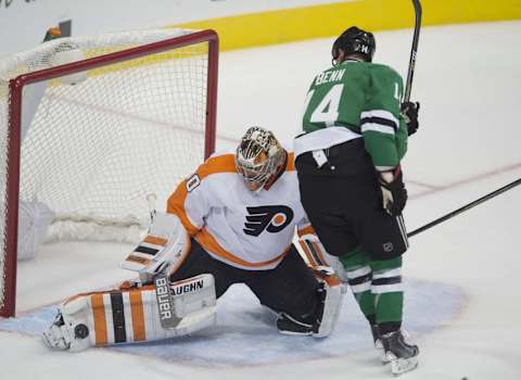 Dec 11, 2015; Dallas, TX, USA; Philadelphia Flyers goalie Michal Neuvirth (30) makes a save as Dallas Stars left wing Jamie Benn (14) skates around during the first period at the American Airlines Center. Mandatory Credit: Jerome Miron-USA TODAY Sports