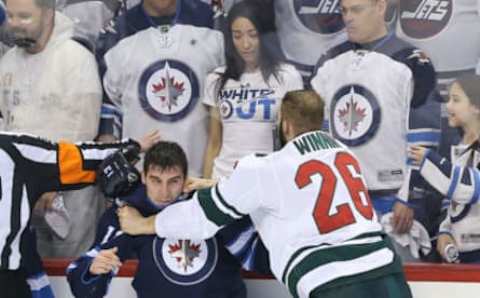 WINNIPEG, MANITOBA – APRIL 13: Brandon Tanev #13 of the Winnipeg Jets fights Daniel Winnik #26 of the Minnesota Wild in Game Two of the Western Conference First Round during the 2018 NHL Stanley Cup Playoffs on April 13, 2018, at Bell MTS Place in Winnipeg, Manitoba, Canada. (Photo by Jason Halstead /Getty Images)