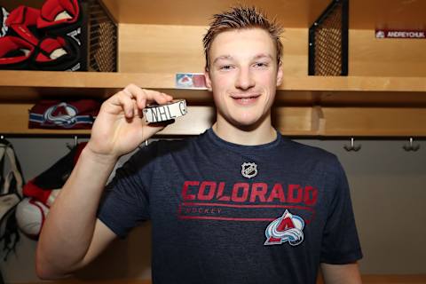 DENVER, CO – APRIL 15: Cale Makar #8 of the Colorado Avalanche holds his first career NHL goal that he scored in his first NHL game against the Calgary Flames in Game Three of the Western Conference First Round during the 2019 NHL Stanley Cup Playoffs at the Pepsi Center on April 15, 2019 in Denver, Colorado. The Avalanche defeated the Flames 6-2. (Photo by Michael Martin/NHLI via Getty Images)