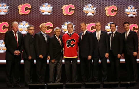 Jun 27, 2014; Philadelphia, PA, USA; Samuel Bennett poses for a photo with team officials after being selected as the number four overall pick to the Calgary Flames in the first round of the 2014 NHL Draft at Wells Fargo Center. Mandatory Credit: Bill Streicher-USA TODAY Sports