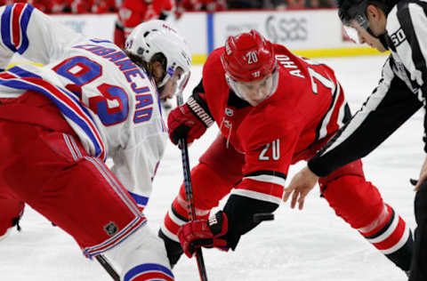 RALEIGH, NC – FEBRUARY 19: Sebastian Aho #20 of the Carolina Hurricanes faces off against Mika Zibanejad #93 of the New York Rangers during an NHL game on February 19, 2019 at PNC Arena in Raleigh, North Carolina. (Photo by Karl DeBlaker/NHLI via Getty Images)