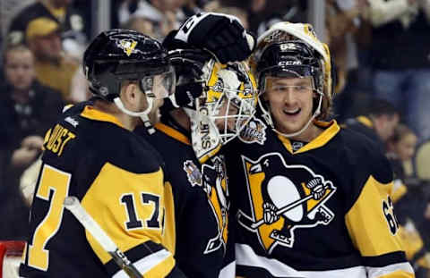 NHL Power Rankings: Pittsburgh Penguins right wing Bryan Rust (17) and goalie Matt Murray (middle) and left wing Carl Hagelin (62) celebrate after defeating the New York Rangers at the PPG PAINTS Arena. The Penguins won 7-2. Mandatory Credit: Charles LeClaire-USA TODAY Sports