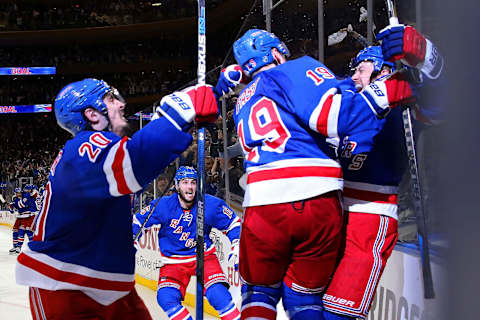 Derek Stepan #21 of the New York Rangers celebrates with Chris Kreider #20, Jesper Fast #19 and his team after scoring the game winning goal in overtime (Photo by Bruce Bennett/Getty Images)