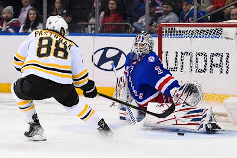 Feb 15, 2022; New York, New York, USA; New York Rangers goaltender Igor Shesterkin (31) makes a save on Boston Bruins right wing David Pastrnak (88) during overtime at Madison Square Garden. Mandatory Credit: Dennis Schneidler-USA TODAY Sports