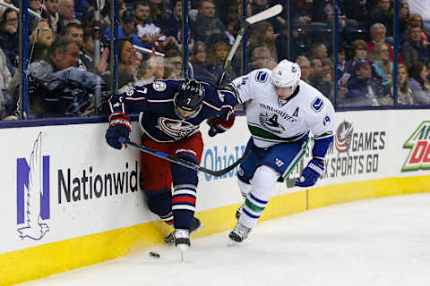 Feb 9, 2017; Columbus, OH, USA; Columbus Blue Jackets defenseman Jack Johnson (7) kicks the puck away from Vancouver Canucks left wing Alex Burrows (14) during the third period at Nationwide Arena. Vancouver shutout the Blue Jackets 3-0. Mandatory Credit: Russell LaBounty-USA TODAY Sports