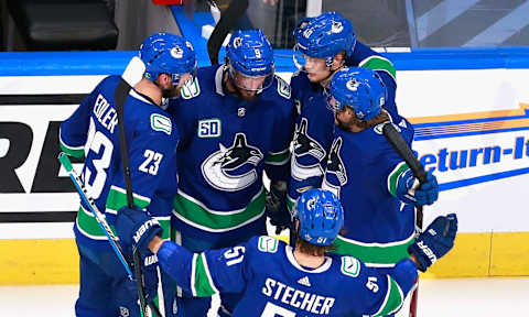 EDMONTON, ALBERTA – AUGUST 17: The Vancouver Canucks celebrate a goal by J.T. Miller #9 (C) against the St. Louis Blues at 40 seconds of the second period in Game Four of the Western Conference First Round during the 2020 NHL Stanley Cup Playoffs at Rogers Place on August 17, 2020 in Edmonton, Alberta, Canada. (Photo by Jeff Vinnick/Getty Images)