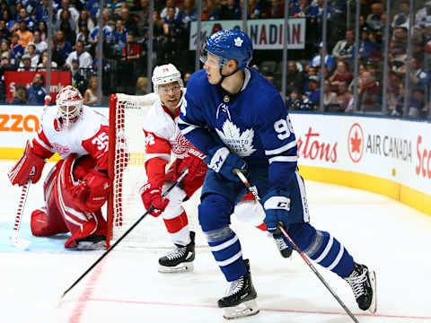 TORONTO, ON – SEPTEMBER 28: Yegor Korshkov #96 of the Toronto Maple Leafs passes the puck away as Madison Bowey #74 of the Detroit Red Wings defends during an NHL pre-season game at Scotiabank Arena on September 28, 2019 in Toronto, Canada. (Photo by Vaughn Ridley/Getty Images)