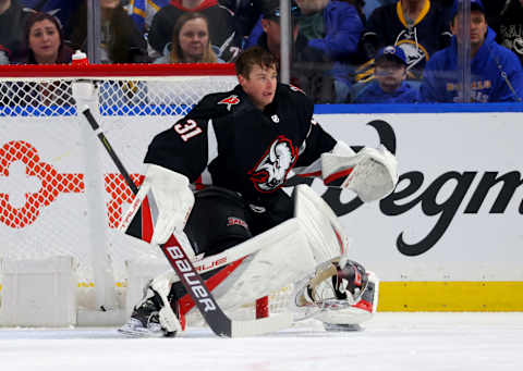 Mar 4, 2023; Buffalo, New York, USA; Buffalo Sabres goaltender Eric Comrie (31) looses his helmet during the pay in the second period against the Tampa Bay Lightning at KeyBank Center. Mandatory Credit: Timothy T. Ludwig-USA TODAY Sports