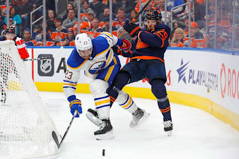 Oct 18, 2022; Edmonton, Alberta, CAN; Edmonton Oilers forward Leon Draisaitl (29) and Buffalo Sabres defensemen Mattias Samuelsson (23) battle along the boards for a loose puck during the third period at Rogers Place. Mandatory Credit: Perry Nelson-USA TODAY Sports