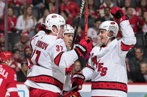 DETROIT, MI – NOVEMBER 24: Sebastian Aho #20 of the Carolina Hurricanes celebrates his second period goal with teammates Andrei Svechnikov #37 and Teuvo Teravainen #86 during an NHL game against the Detroit Red Wings at Little Caesars Arena on November 24, 2019 in Detroit, Michigan. (Photo by Dave Reginek/NHLI via Getty Images)