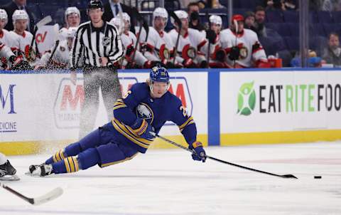 Feb 17, 2022; Buffalo, New York, USA; Buffalo Sabres defenseman Rasmus Dahlin (26) falls as he goes for a loose puck d2 against the Ottawa Senators at KeyBank Center. Mandatory Credit: Timothy T. Ludwig-USA TODAY Sports