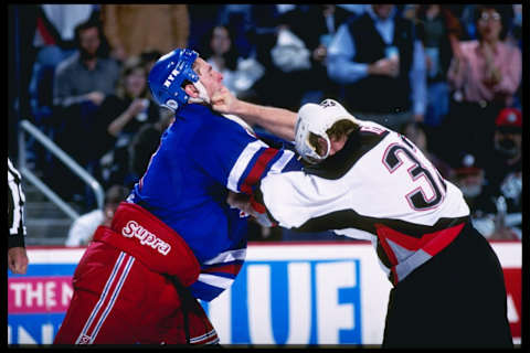 4 Apr 1997: Eric Cairns of the New York Rangers fights with Rob Ray of the Buffalo Sabres during their 5-2 loss to the Sabres at Marine Midland Arena in Buffalo, New York. Mandatory Credit: Rick Stewart /Allsport