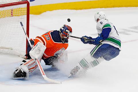 Apr 29, 2022; Edmonton, Alberta, CAN; Edmonton Oilers goaltender Mikko Koskinen (19) makes a save on a shot by Vancouver Canucks forward Brock Boeser (6) during the shoot-out at Rogers Place. Mandatory Credit: Perry Nelson-USA TODAY Sports